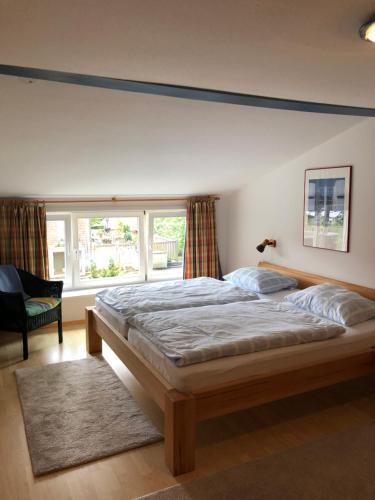 a bedroom with a large bed and a large window at Apartment 1 oder 2 in Wyk auf Föhr