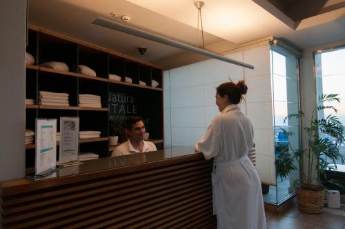a woman standing in front of a counter in a restaurant at Enjoy Viña Del Mar in Viña del Mar