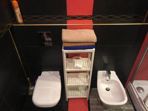 a small bathroom with a sink and a toilet at DAUGAVPILS in Daugavpils