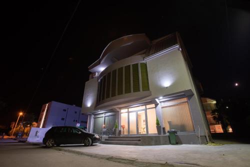 a car parked in front of a house at night at Premium Inn in Gevgelija