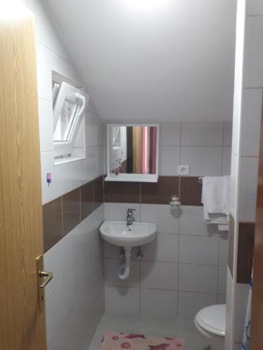 a bathroom with a sink and a toilet at Motel Tetrijeb Sipovo in Šipovo