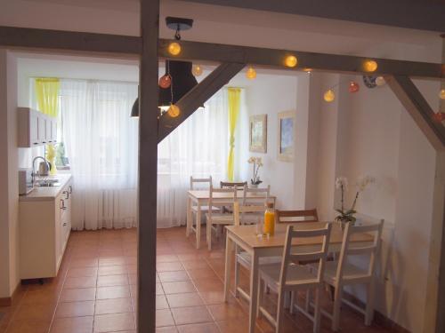 a kitchen and dining room with tables and chairs at Pensjonat Anker pokoje in Ustronie Morskie