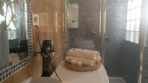a bathroom with a shower with a pile of towels at Dailos' Home in Puerto de Mogán