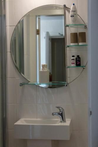 a bathroom with a sink and a mirror on the wall at Ladysmith Guest House in Ullapool
