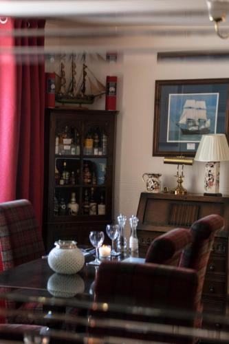 a dining room with a table and chairs at Ladysmith Guest House in Ullapool