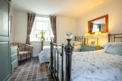 a bedroom with a bed and a mirror at Ladysmith Guest House in Ullapool