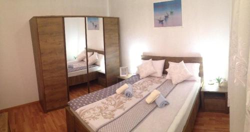a bedroom with a bed with a large mirror at Apartment Dita in Kaštela