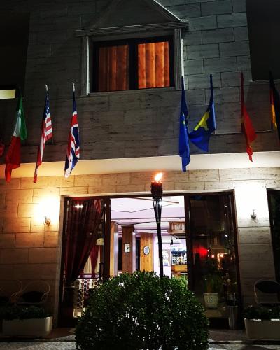 a group of flags hanging from a building at Hotel Ambasador Garden in Lezhë
