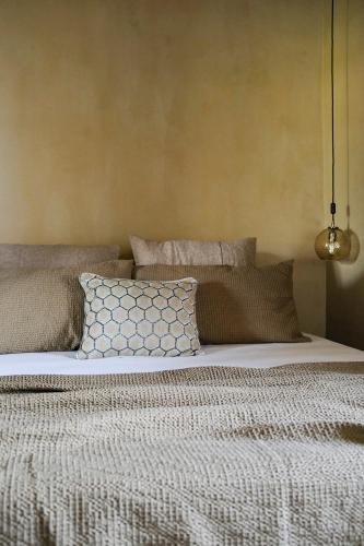 a bed with pillows on it in a bedroom at Borgo Castello Panicaglia in Nocera Umbra