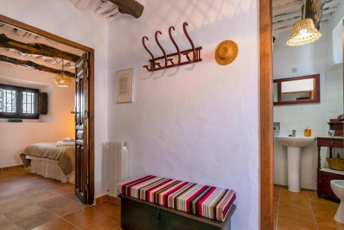 a room with a hallway with a bathroom and a sink at Casa Tita María in Bubión