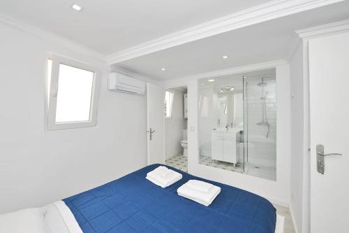 a white room with a blue bed and a shower at Suprema Loft II in Lisbon