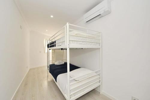 a white bunk bed in a white room at Suprema Loft II in Lisbon