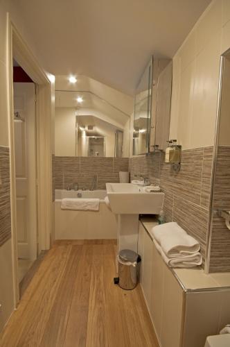 a bathroom with a sink and a mirror at Boscundle Manor in St Austell