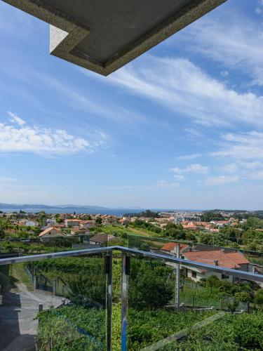 a view of a city from the balcony of a building at Apartamentos Onzamar in Sanxenxo