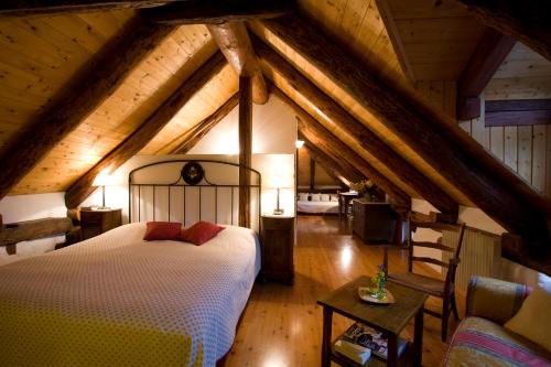 a bedroom with a large bed in a attic at Pensione Ca' Serafina in Lodano