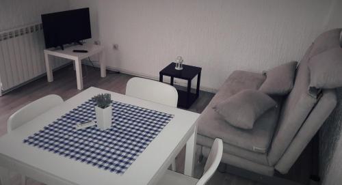 a living room with a table and a couch at Apartments Leonarda in Murter