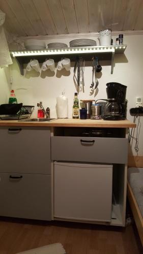 a kitchen with a counter top with pots and pans at Sollyan in Knivsta