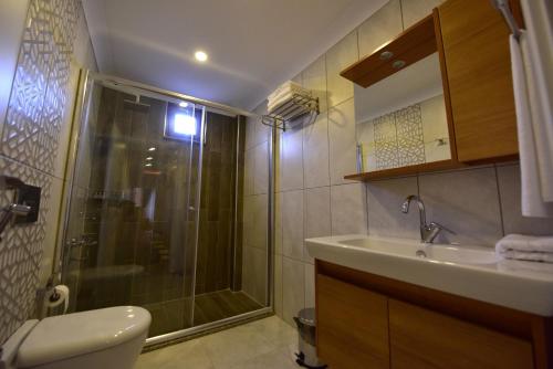 a bathroom with a shower and a sink and a toilet at İnanlar Airport Residence in Trabzon