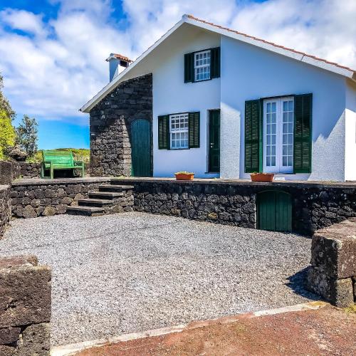 a white house with a stone driveway at eSense - Formosinha in Madalena