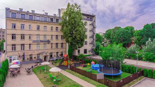 an apartment with a playground in front of a building at RIGAAPARTMENT SONADA Family Aparthotel - Private Parking in Rīga