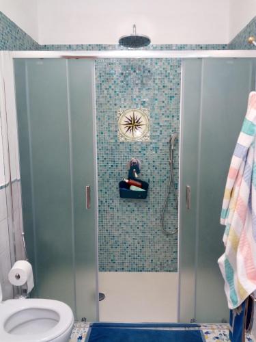 a bathroom with a shower with a toilet at Terrazza sul Mare holidays with experiences in Lipari