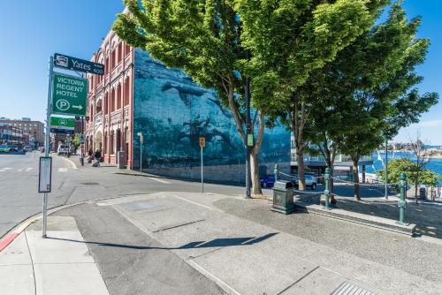 a mural on the side of a building on a street at Victoria Regent Waterfront Hotel & Suites in Victoria