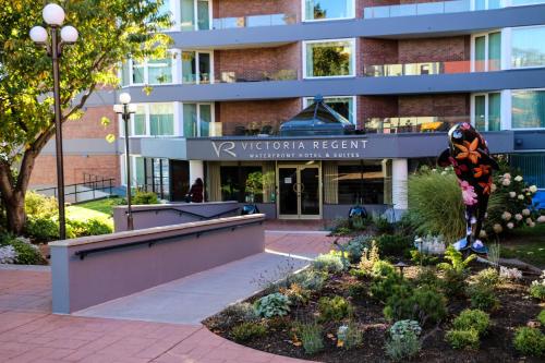 a building with a garden in front of it at Victoria Regent Waterfront Hotel & Suites in Victoria