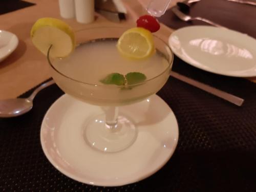 a drink in a martini glass on a table at The Pearl in Hassan