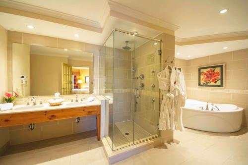 a bathroom with a shower and a tub and a sink at The Water Tower Inn - BW Premier Collection in Sault Ste. Marie