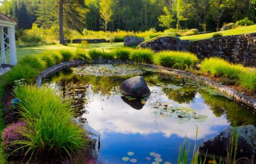a pond in the middle of a garden at Adair Country Inn & Restaurant in Bethlehem