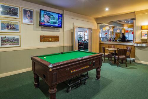 a billiard room with a pool table and a bar at Best Western The Dartmouth Hotel, Golf & Spa in Dartmouth