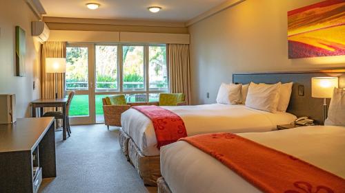 a hotel room with two beds and a window at Scenic Hotel Bay of Islands in Paihia