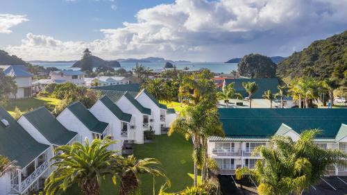 an aerial view of a resort with palm trees at Scenic Hotel Bay of Islands in Paihia