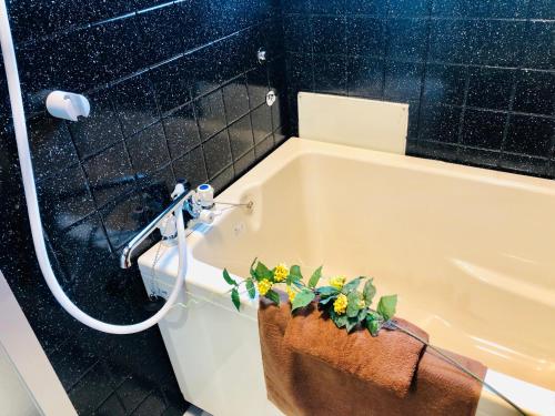 La salle de bains est pourvue d'une baignoire avec des plantes. dans l'établissement 板橋 RCアネックス Rc207, à Tokyo
