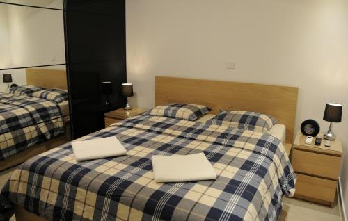 a bedroom with two beds with white pillows on them at Kennedy Deluxe Suites in Nicosia