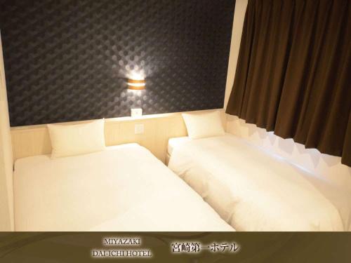a room with two beds in a room at Miyazaki Daiichi Hotel in Miyazaki