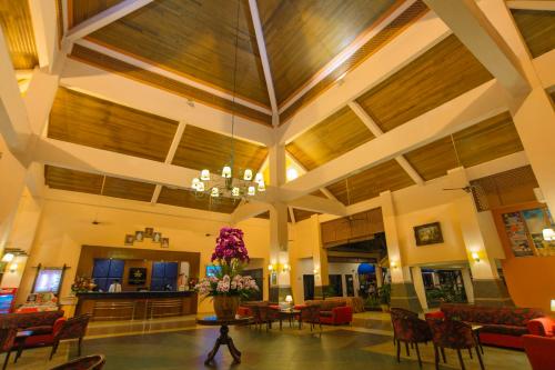 a large lobby with a vase of flowers on a table at Hotel Seri Malaysia Melaka in Melaka
