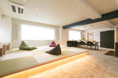 a living room with a couch with pillows on it at Hotel Kado Gosho-Minami Kyoto in Kyoto