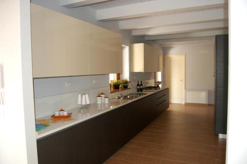 a large kitchen with white counters and a counter top at Country House Poggio Alto in Buonabitacolo