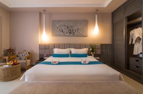 a bedroom with a large bed with two cats on it at Damrei Residence & Spa in Siem Reap