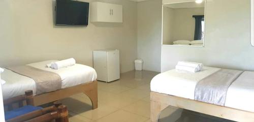 Ein Bett oder Betten in einem Zimmer der Unterkunft Le Aura Inn