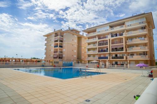 a large apartment building with a swimming pool at Apartment Sunny La Mata (VIÑAMAR VII) in La Mata