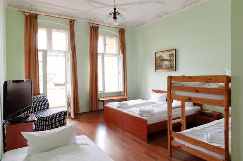 a bedroom with two bunk beds and a television at Hotel Eden am Zoo in Berlin