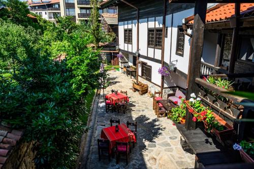 an overhead view of a patio with red tables and chairs at Banskovilla Zlateva House in Bansko