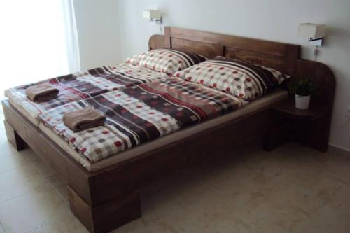 a bed with two pillows on it in a bedroom at Motel Senec in Senec
