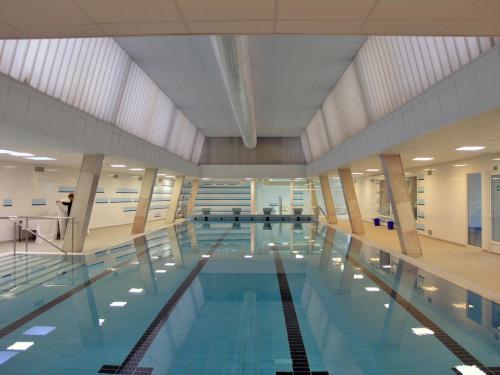 a large swimming pool in a building at Holiday Apartments in Karlovy Vary