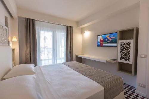 Suite Hotel L'Oasi di Riaciにあるベッド
