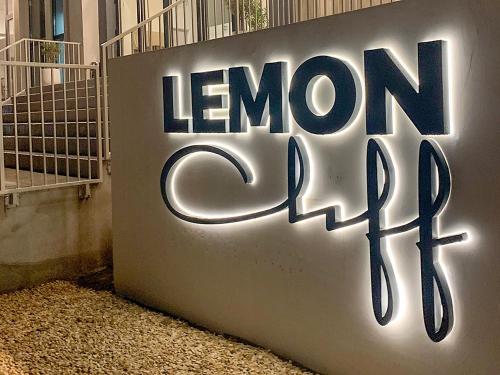 a sign on the side of a building with the words lemon cafe at Lemon Cliff Luxury B&B in Mamaia Nord