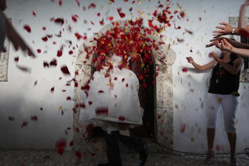 a group of people standing around a altar with red confetti at Hotel Bellevue in Kranj