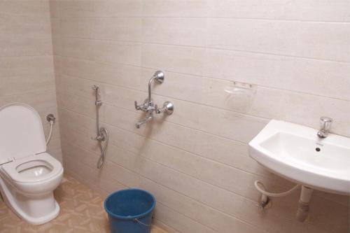 a bathroom with a toilet and a sink at Viva Guest House in Panaji
